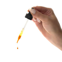 Hand holding dropper liquid anti-inflammatory food supplement